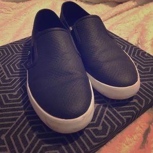 Black flat slip-on sneakers by guess