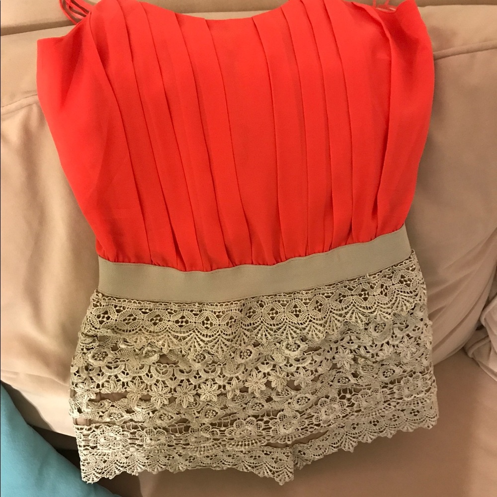 Orange and beige romper with beautiful detail.