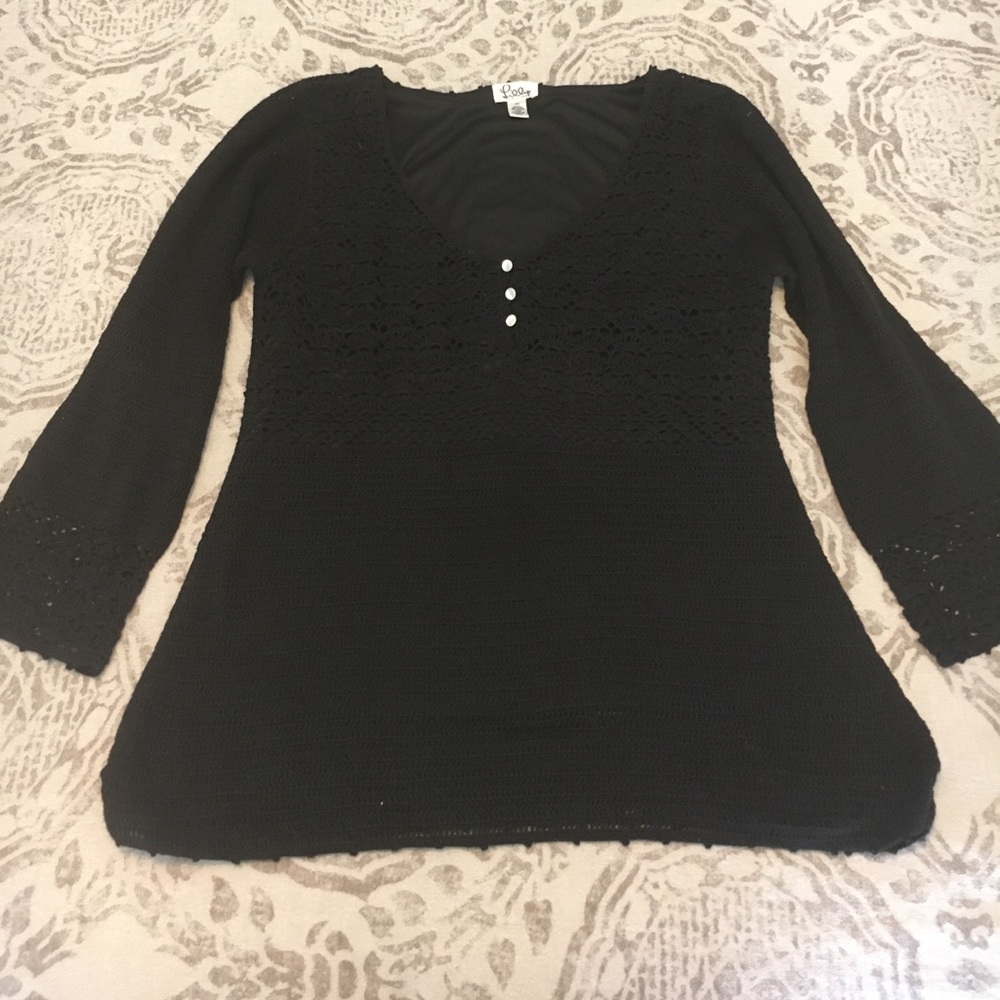 Black crochet pullover with long sleeves.