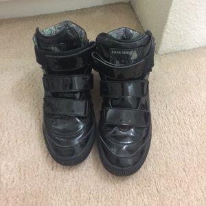 Intentionally distressed patent high tops