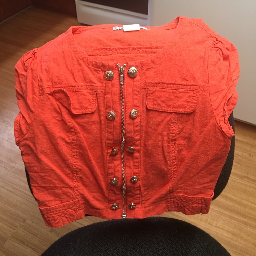 Super cute. Orange "vest" type shirt.