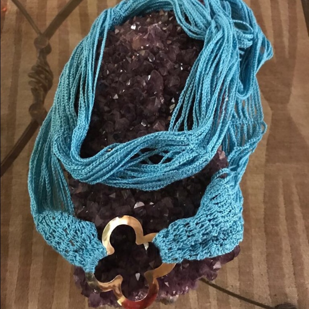 Blue scarf w/ a gold charm