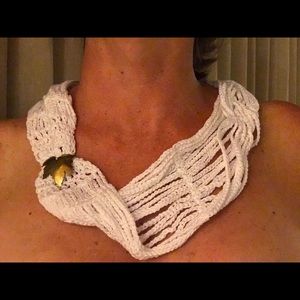 White scarf with gold charm