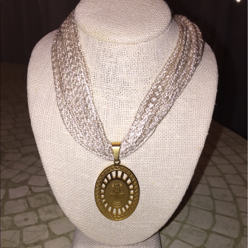 Beige necklace with charm