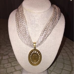 Beige necklace with charm