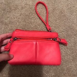 A pink wristlet with black&white strips inside