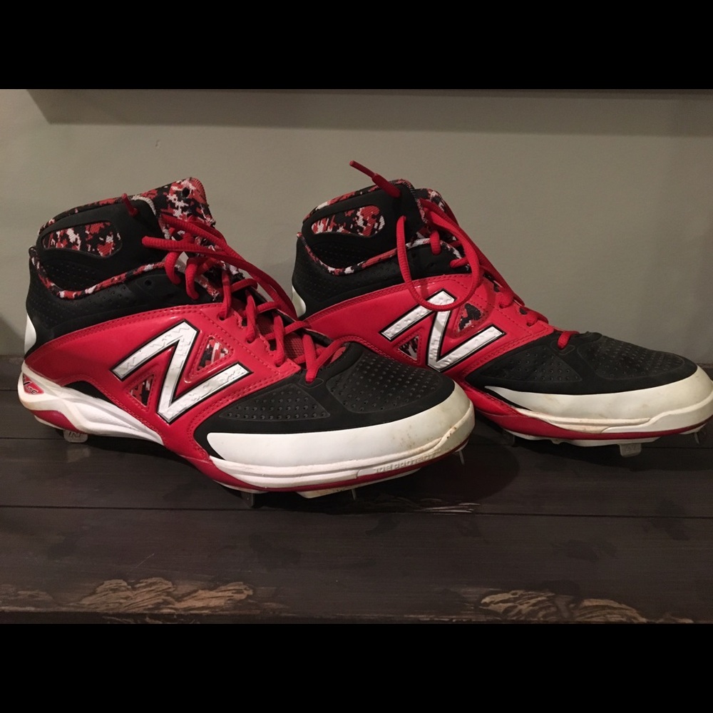 Red and black high top baseball metal cleats.