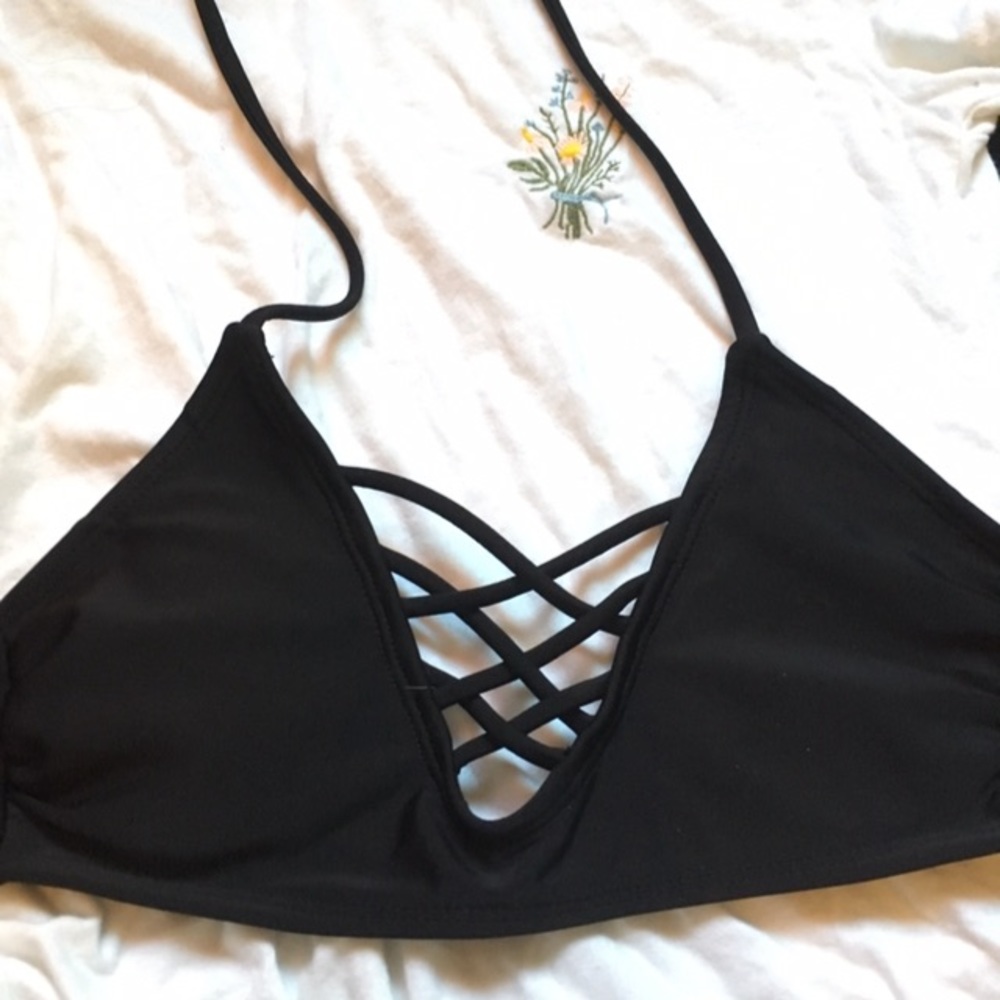 Black bathing suit top with crosses in the middle