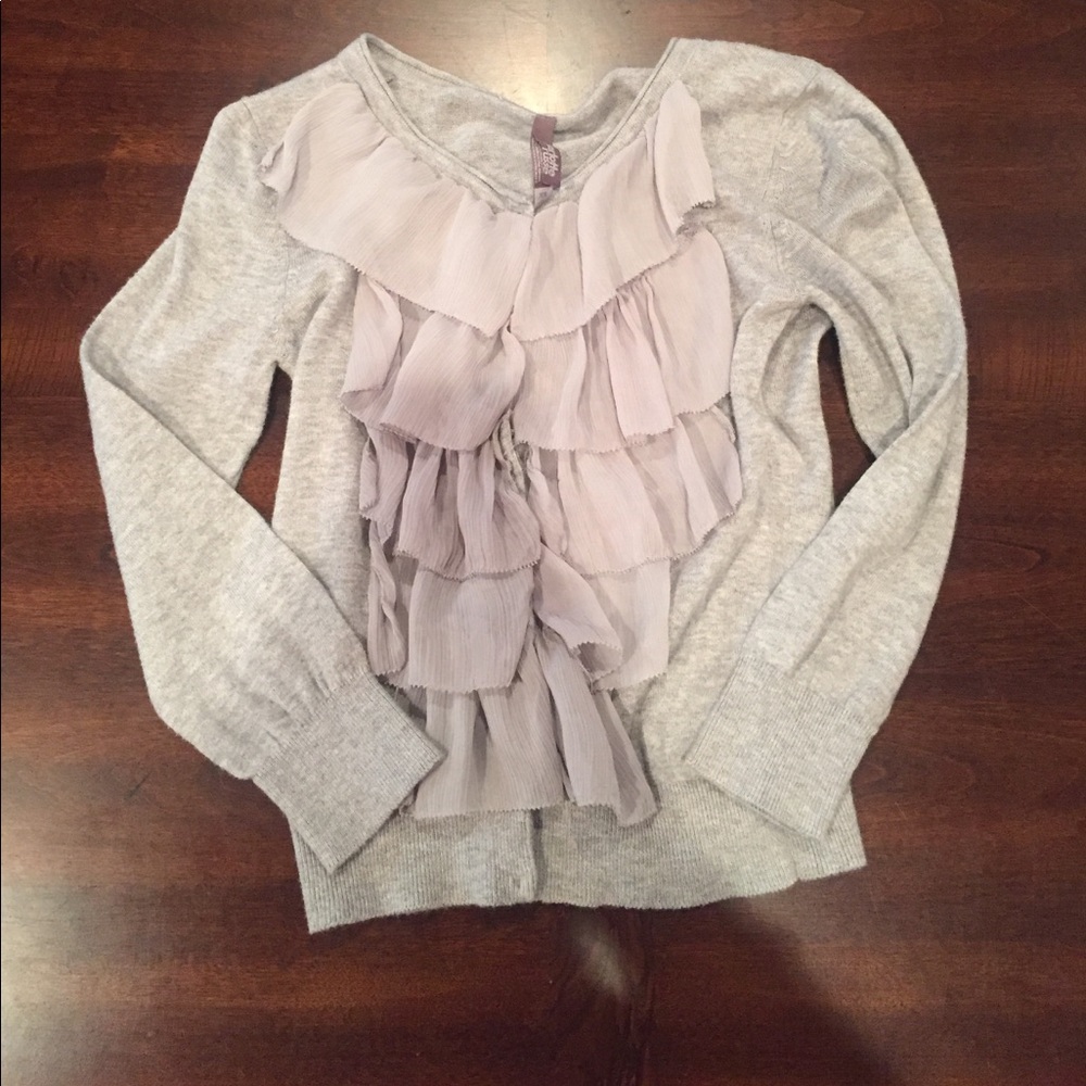 Gray sweater with frills on the front.