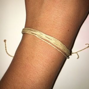 Cream colored pura vida bracelet