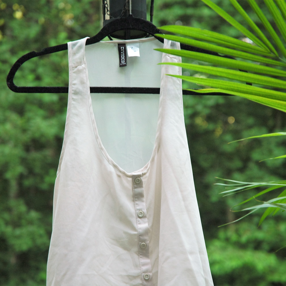 Creme colored sleeveless blouse