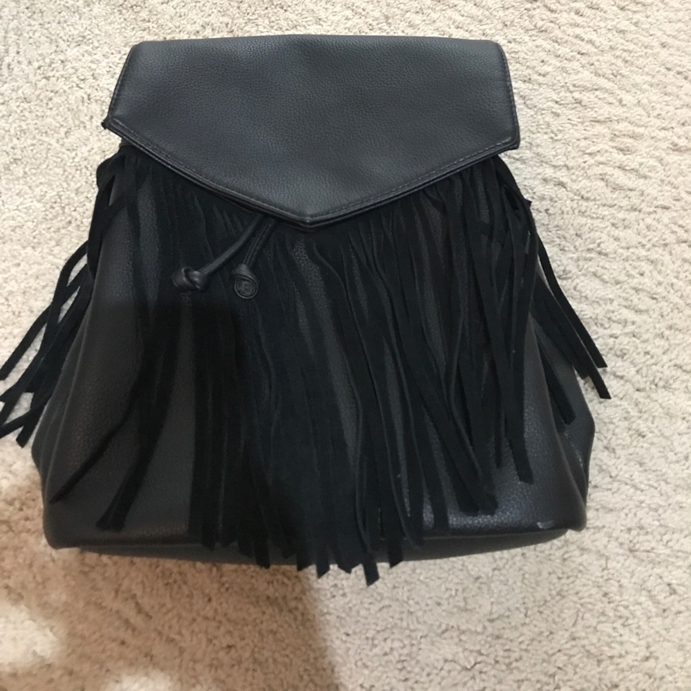 Black leather back pack. Envelope flap and fringe.