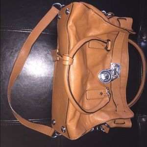 Brown tote bag with silverware.