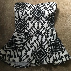 Sleeveless white and black patterned peplum top