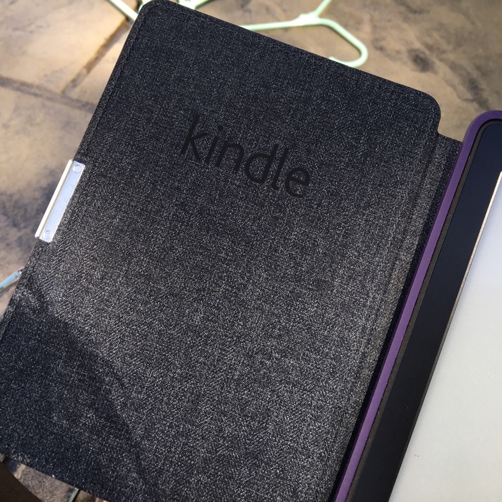 Reading Kindle with a purple case (and charger)