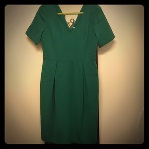 Green v-neck work dress, with gold zipper on back