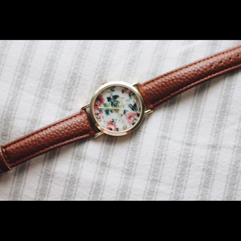 Floral wristwatch with brown (faux) leather band.