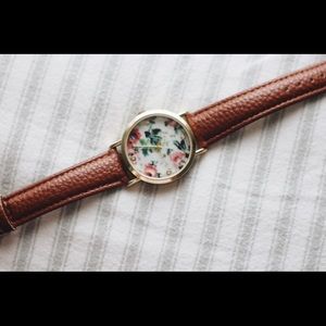 Floral wristwatch with brown (faux) leather band.