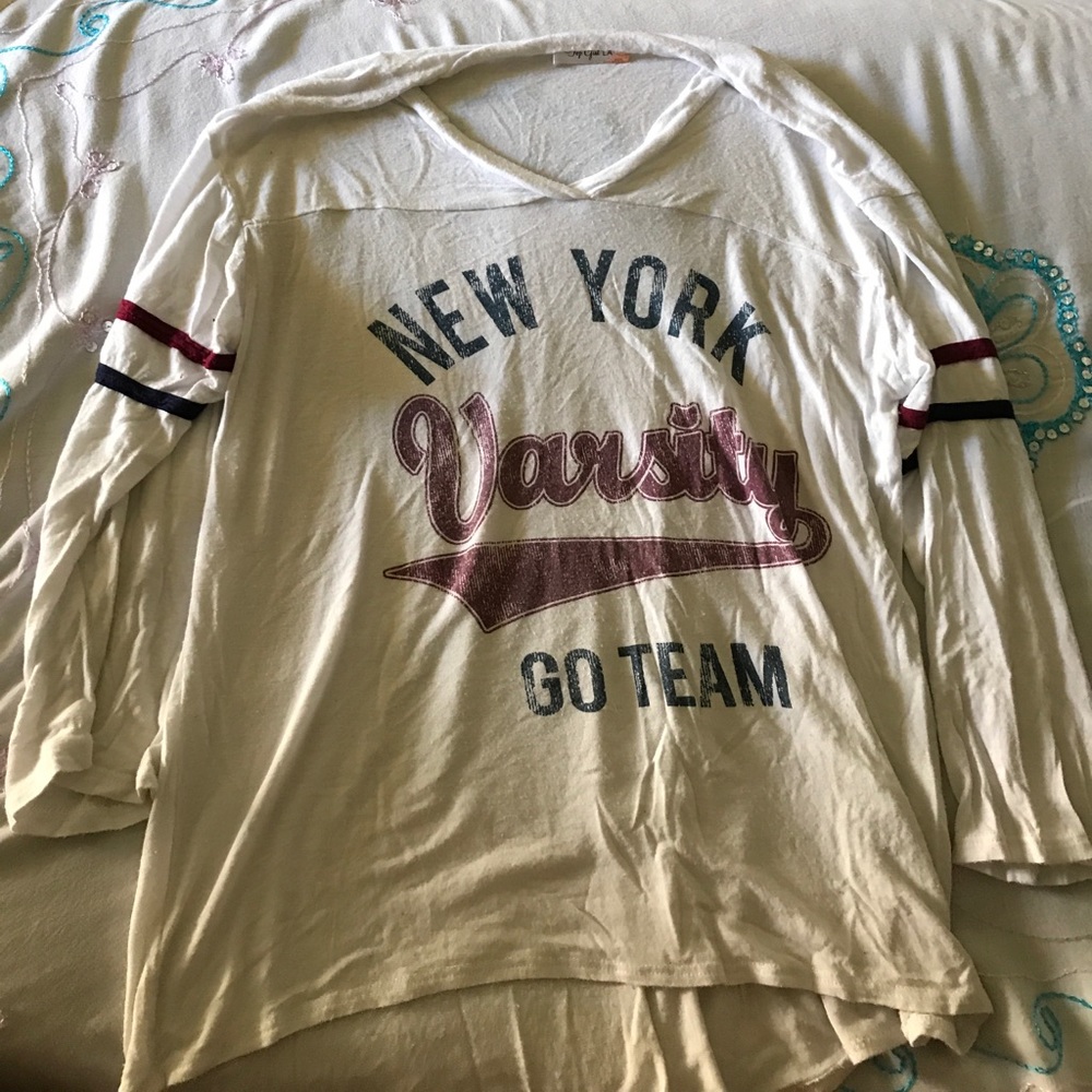 White shirt that says varsity go team