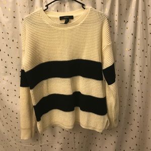 Cream sweater with black stripes.