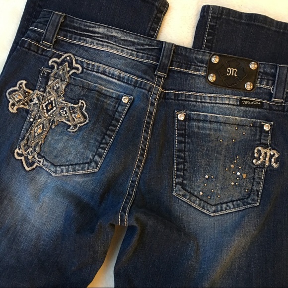 All Listings Product Description pair of mid-rise boot cut miss me jeans styled with embroidery on.