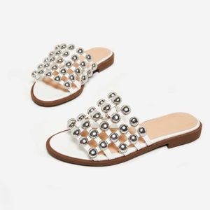 White leather sliders with silver studs