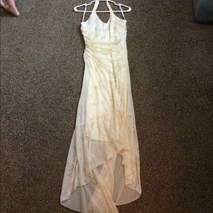 Cream colored high low halter with gold details
