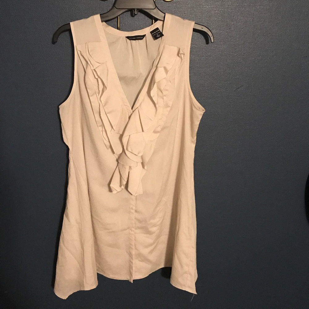Cream sleeveless tunic top.