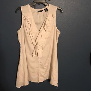 Cream sleeveless tunic top.