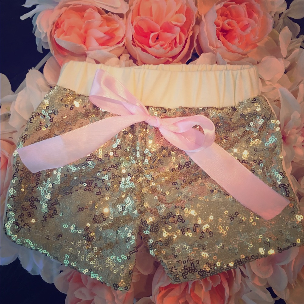 Gold sequin shorts with pink bow