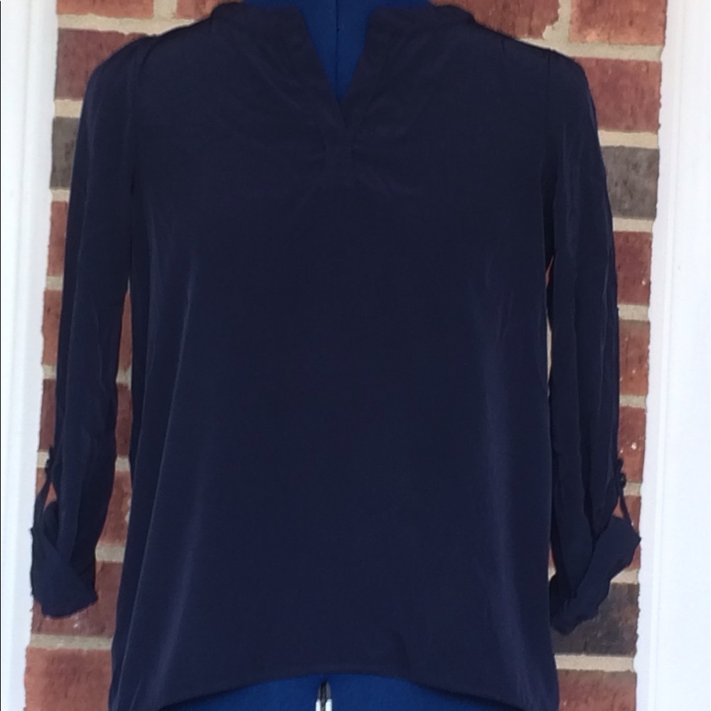 A navy blue Soprano three-quarter length blouse.