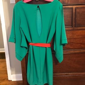 Bright green dress with coral sash.