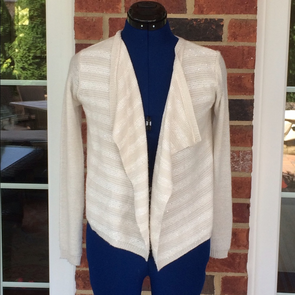 A cream Cherokee sweater worn lightly.