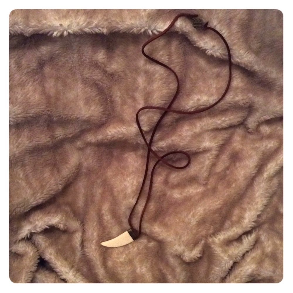 Brown leather with bone tusk charm necklaces.