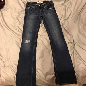 Medium- dark wash, distressed, boot cut jeans.