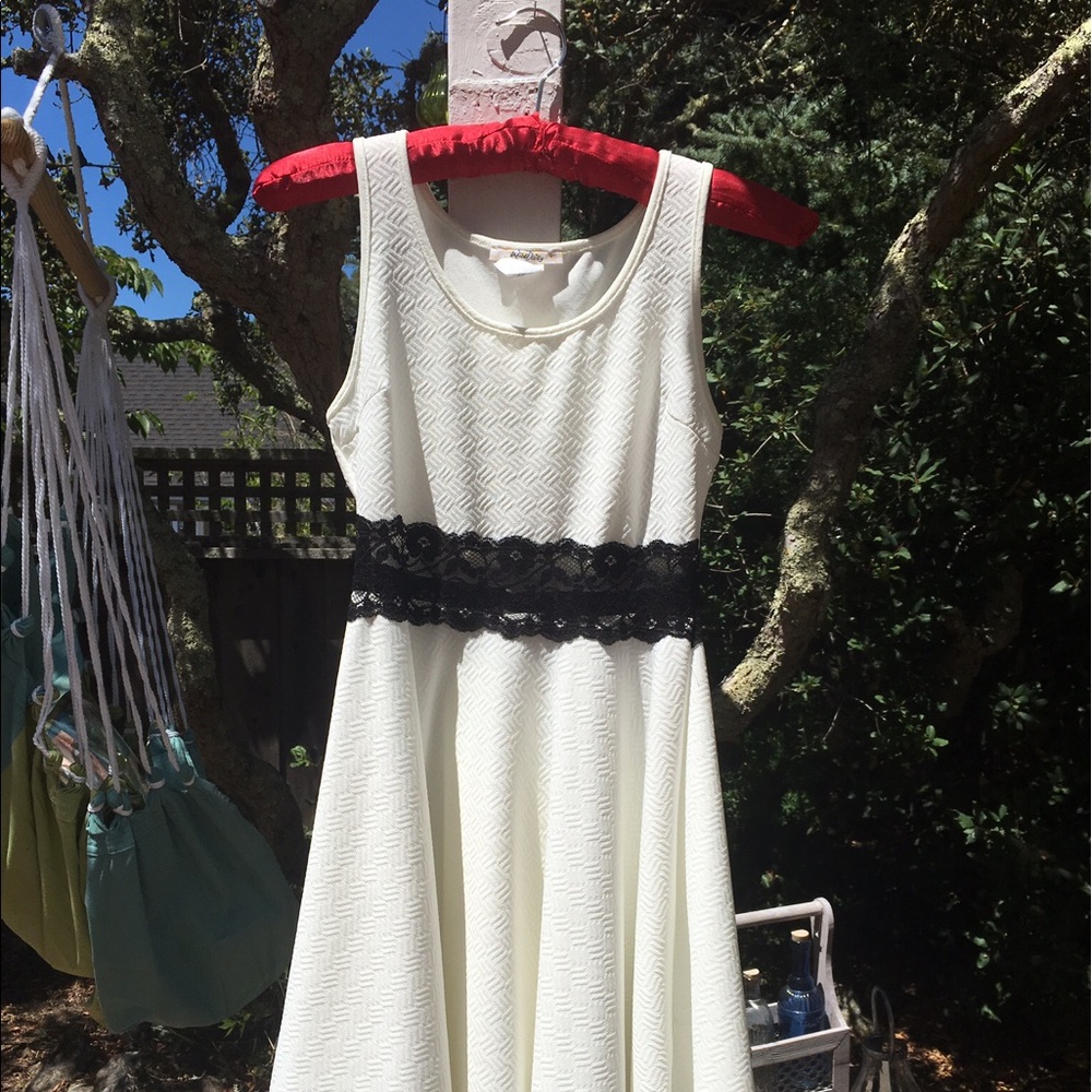 White dress w sheer lace strip at waist.