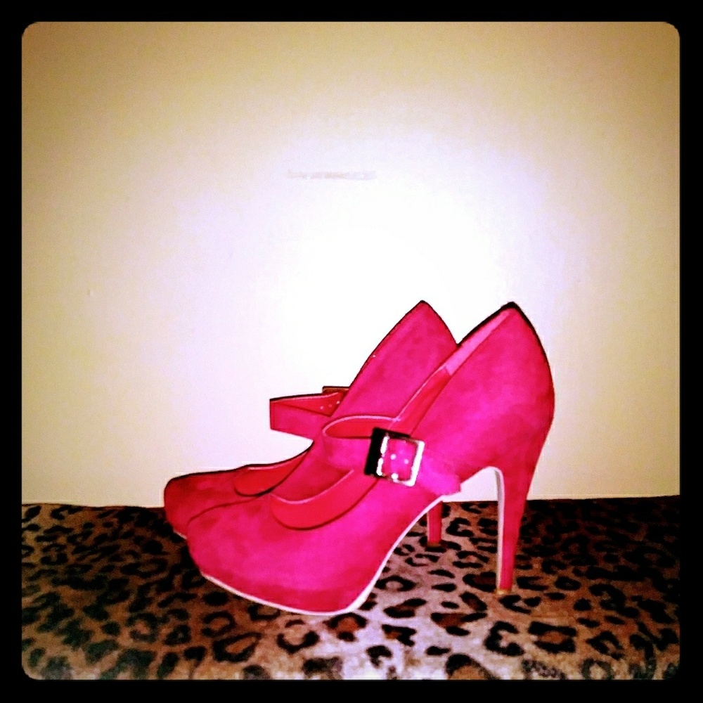 Red suede pumps with strap, gold buckle.
