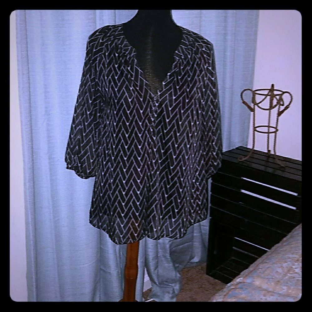 Sheer black top with white chevron pattern.