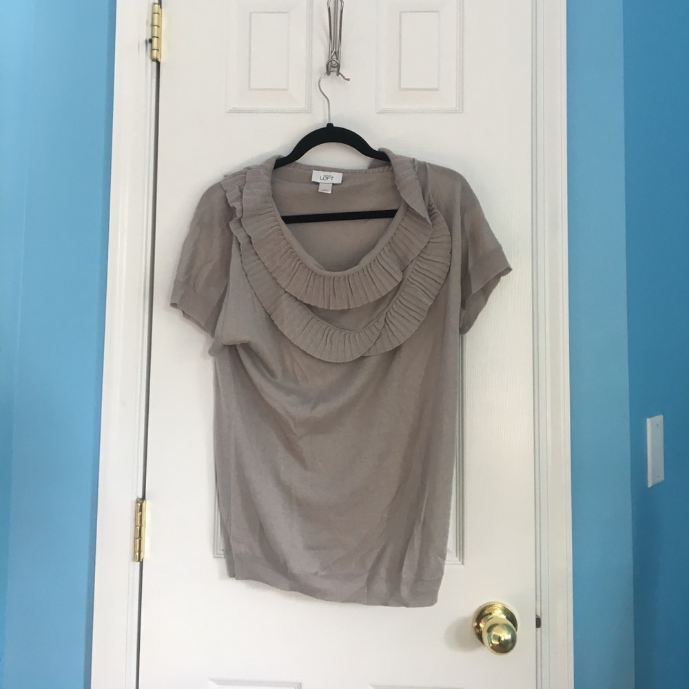 grey top with ruffled neckline