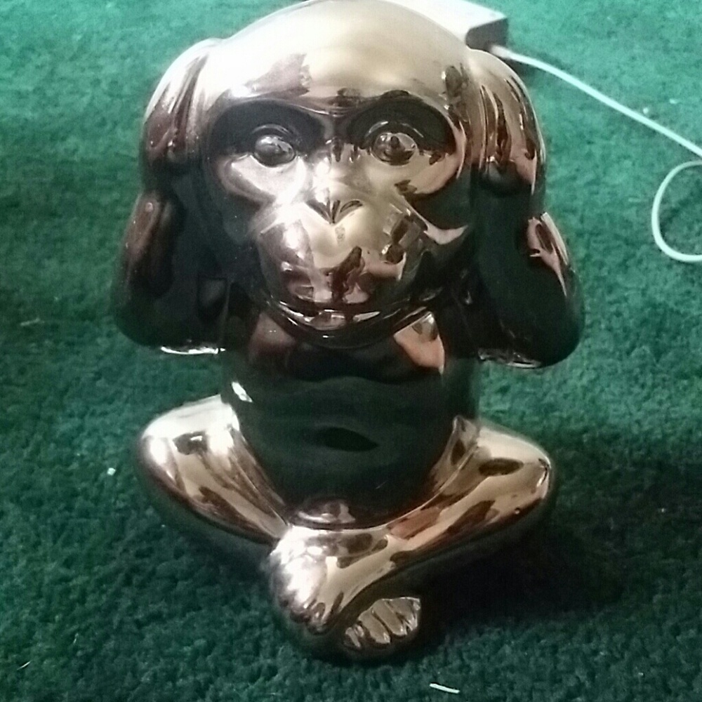 Monky ceramic statue in a metallic silver