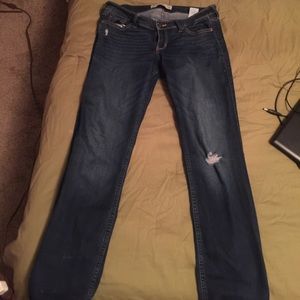 Dark Size 13 Hollister jeans with a ripped knee