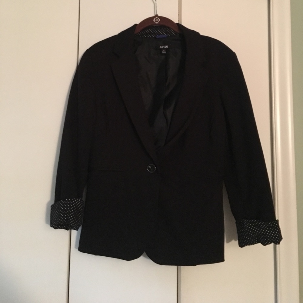 Black blazer with white polka dot lining on sleeve