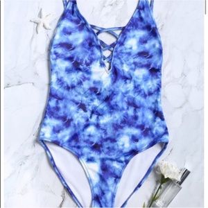 a blue bleached one piece swimsuit