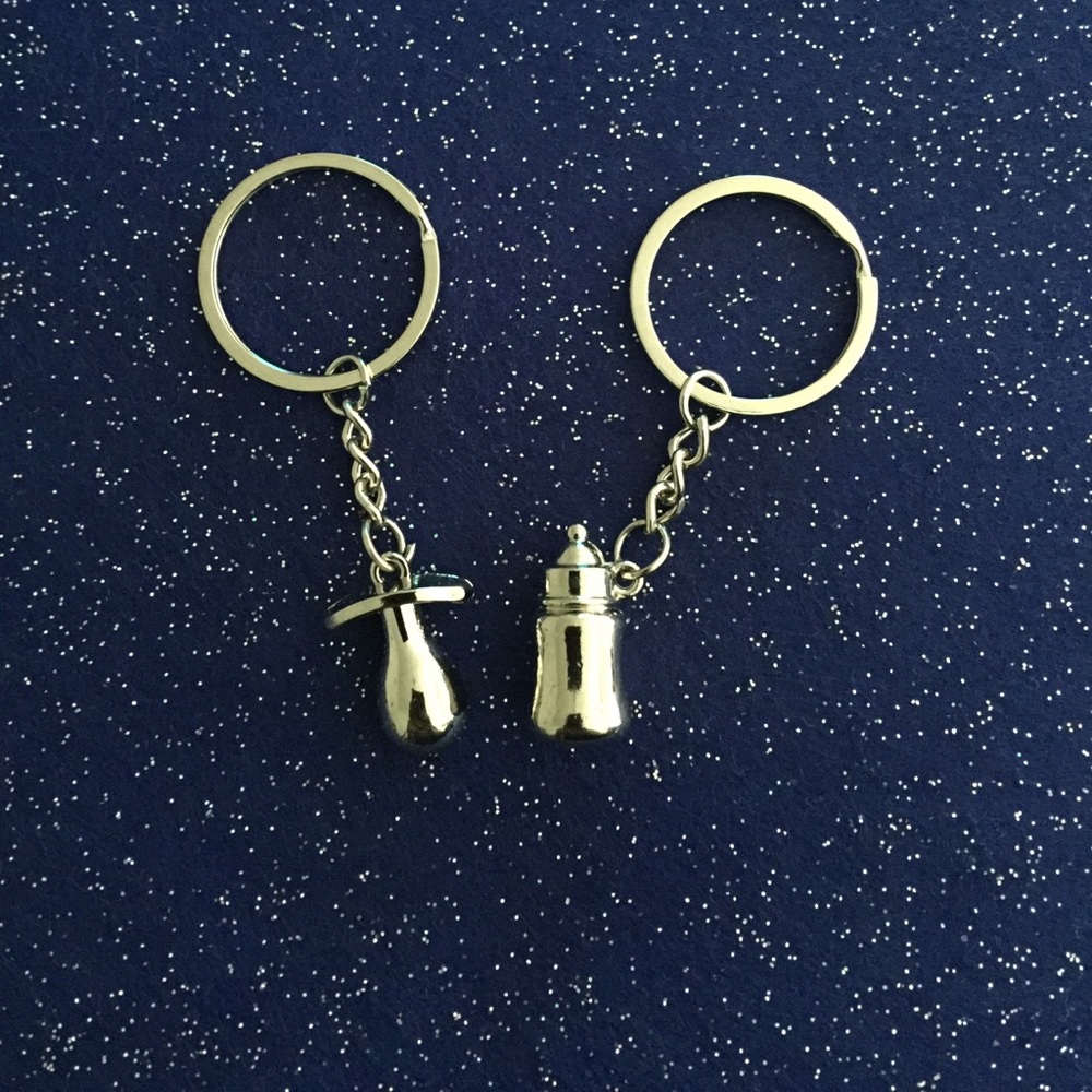 pacifier and a baby bottle keychain set