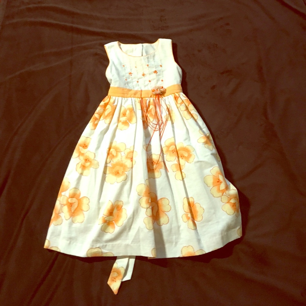 White dress with orange flowers.