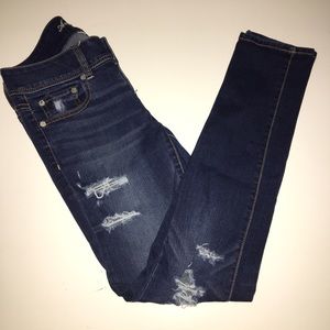 Distressed low rise blue jeans