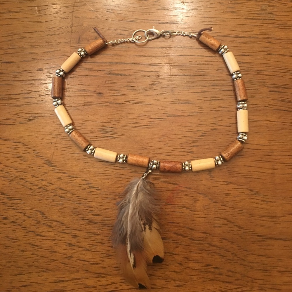 Handmade beaded choker with feather accent.