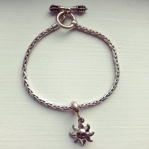 Silver tone sun charm toggle bracelet
