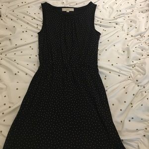 Black dress with brown polka dots. Cinched waist.