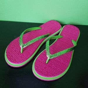 Pink and green flip flops